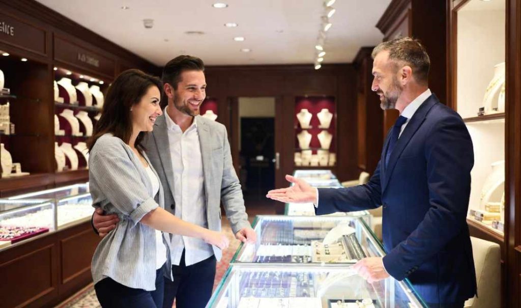 a couple talking to a jewelry store owner